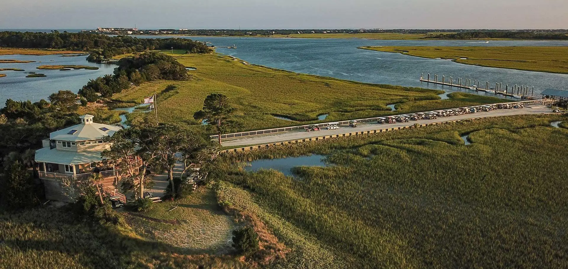 A bridge over water with grass on both sides.