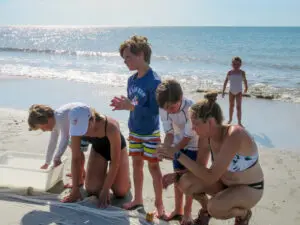 A group of people standing on top of a beach.