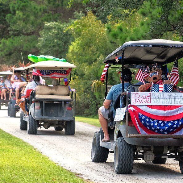Decorated golf carts parade with American flags